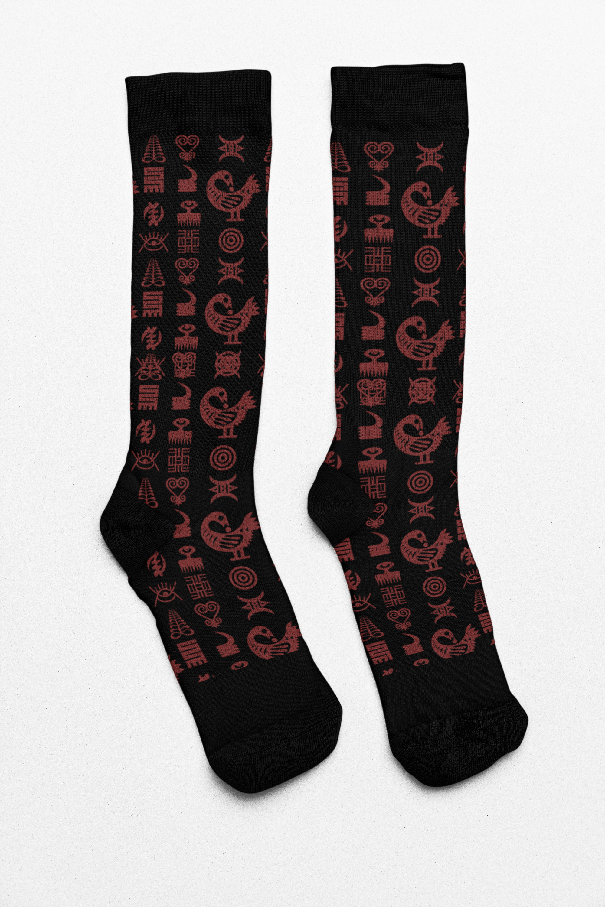 Crew socks featuring traditional Ghanaian Adinkra symbols in an Afrocentric pattern representing wisdom, strength, unity, perseverance, and African cultural heritage.