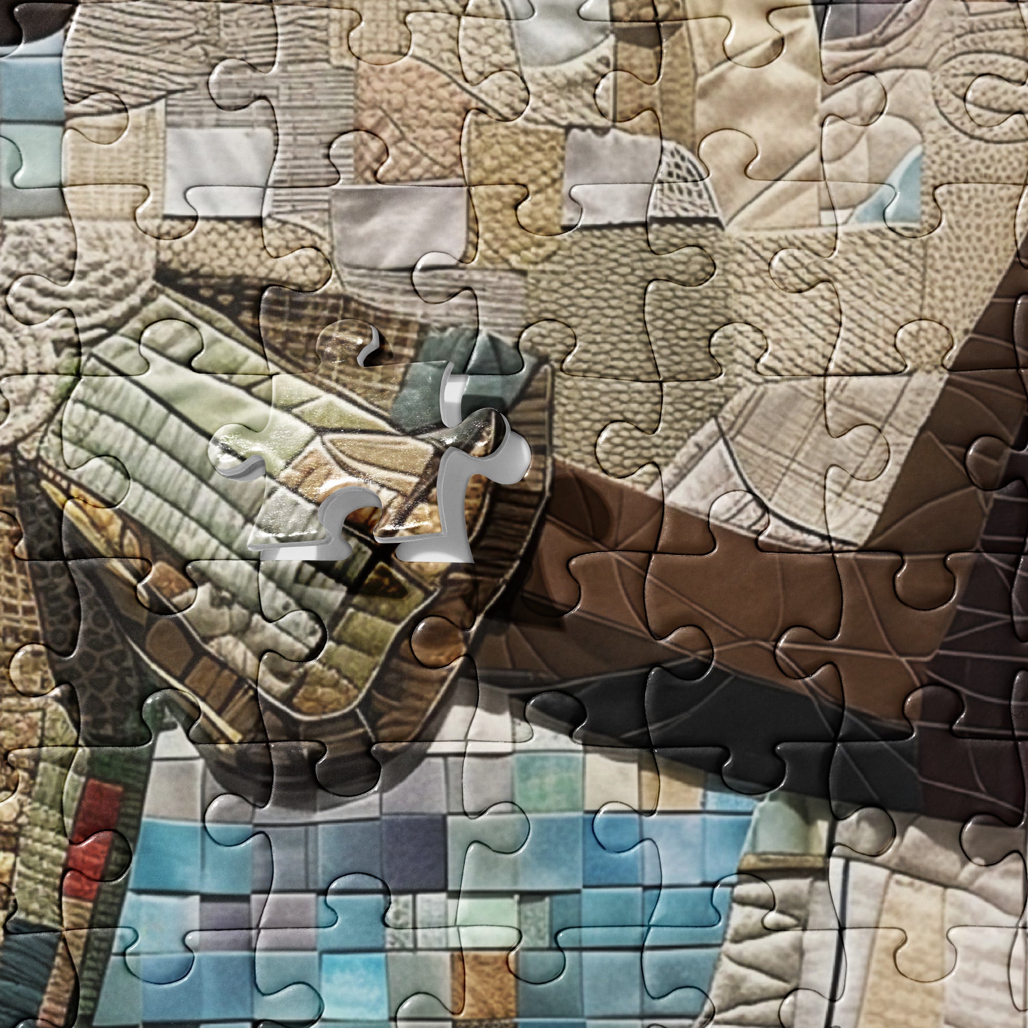 A close-up of a jigsaw puzzle featuring a quilted patchwork design with a central clock motif and a blue tiled section at the bottom, photographed from above.