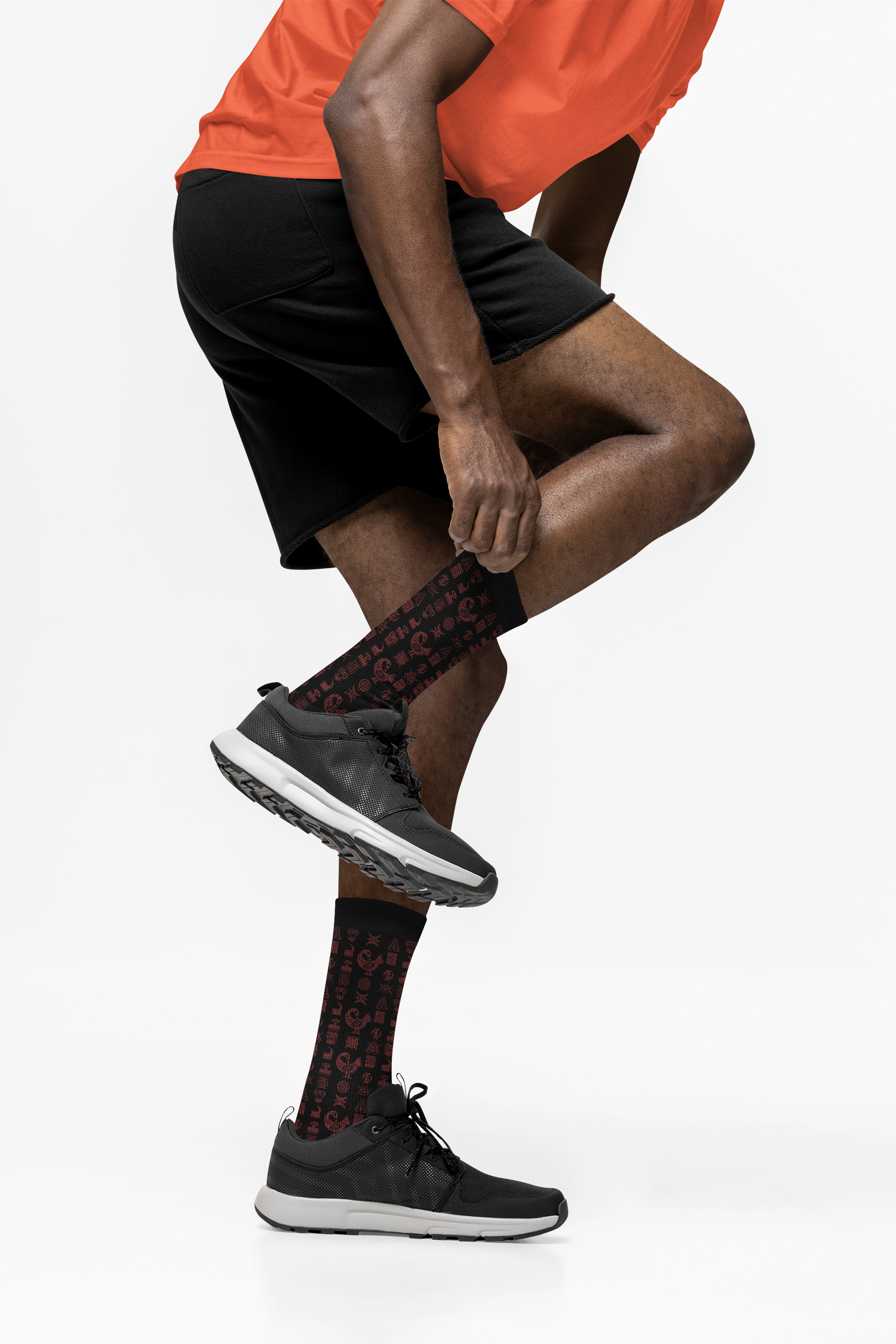 Crew socks featuring traditional Ghanaian Adinkra symbols in an Afrocentric pattern representing wisdom, strength, unity, perseverance, and African cultural heritage.