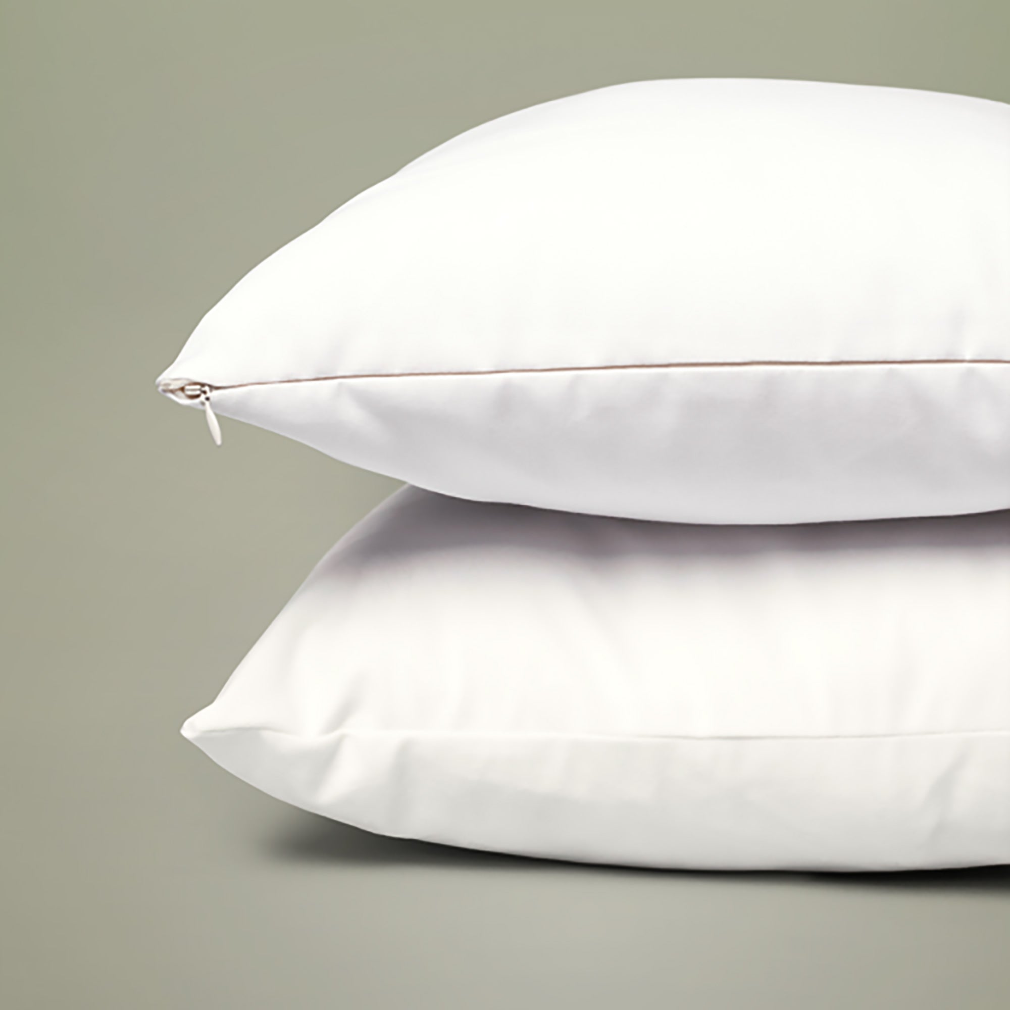 Close up image of two throw pillows featuring the closed invisible zipper.