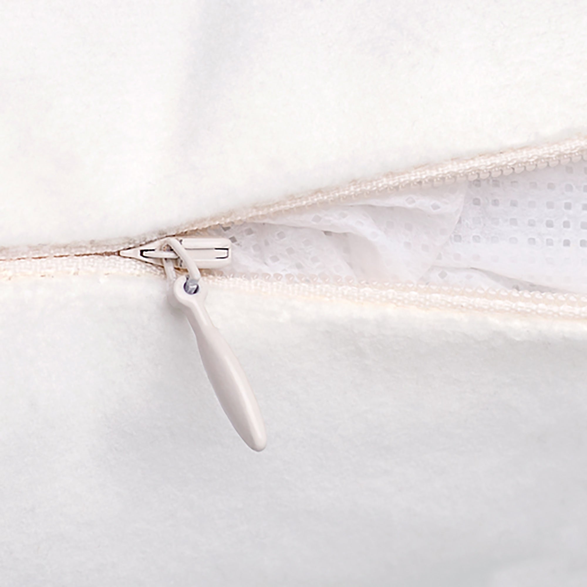 Close up view of the concealed zipper on a throw pillow.