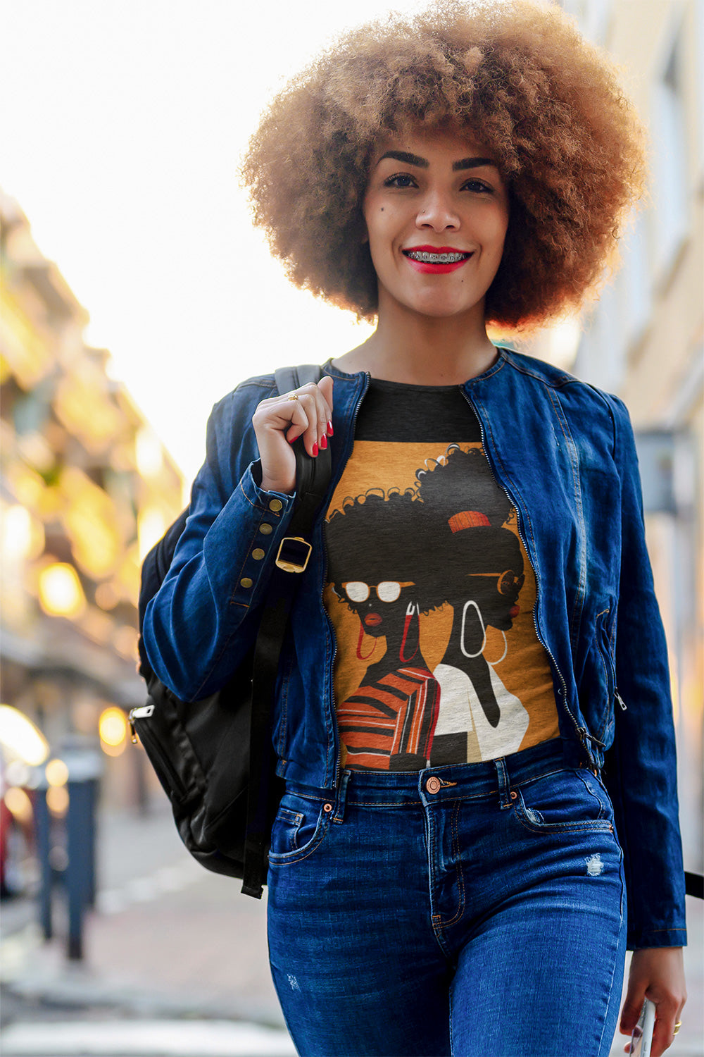 Two Black Women silhouette wearing fashionable eyewear on an orange background, featured on an Afrocentric unisex tee shirt