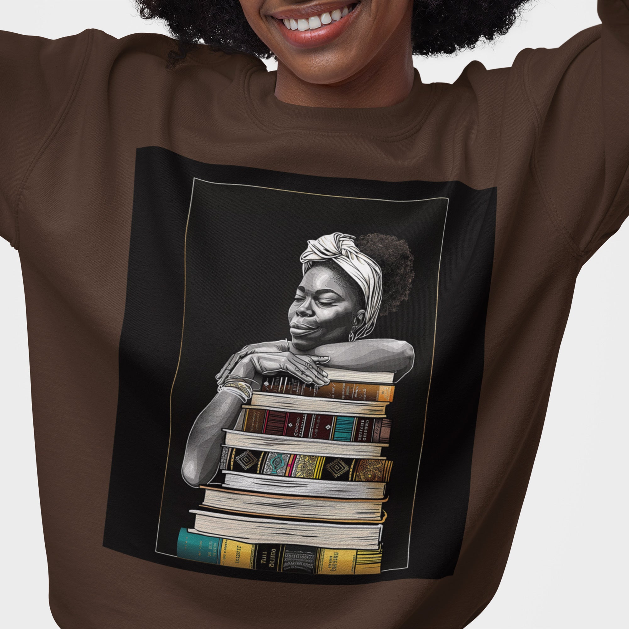 Afrocentric unisex sweatshirt featuring a Black woman embracing books. Cozy crewneck celebrating education, knowledge, freedom, and generational legacy.