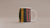 Video of Afrocentric abstract coffee mug featuring bold geometric shapes and textured patterns in red, gold, black, and cream.