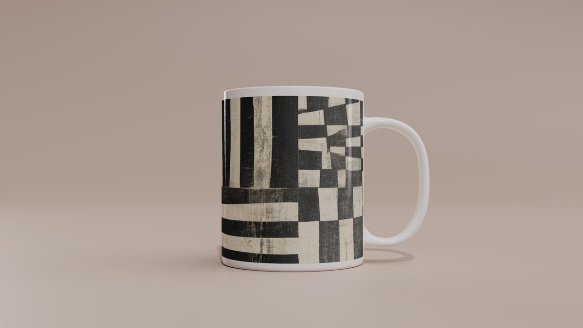 Video of an 11 oz  Afrocentric geometric coffee mug featuring black, creme and red abstract shapes, arches, stripes and checkerboard patterns.
