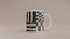 Video of an 11 oz  Afrocentric geometric coffee mug featuring black, creme and red abstract shapes, arches, stripes and checkerboard patterns.