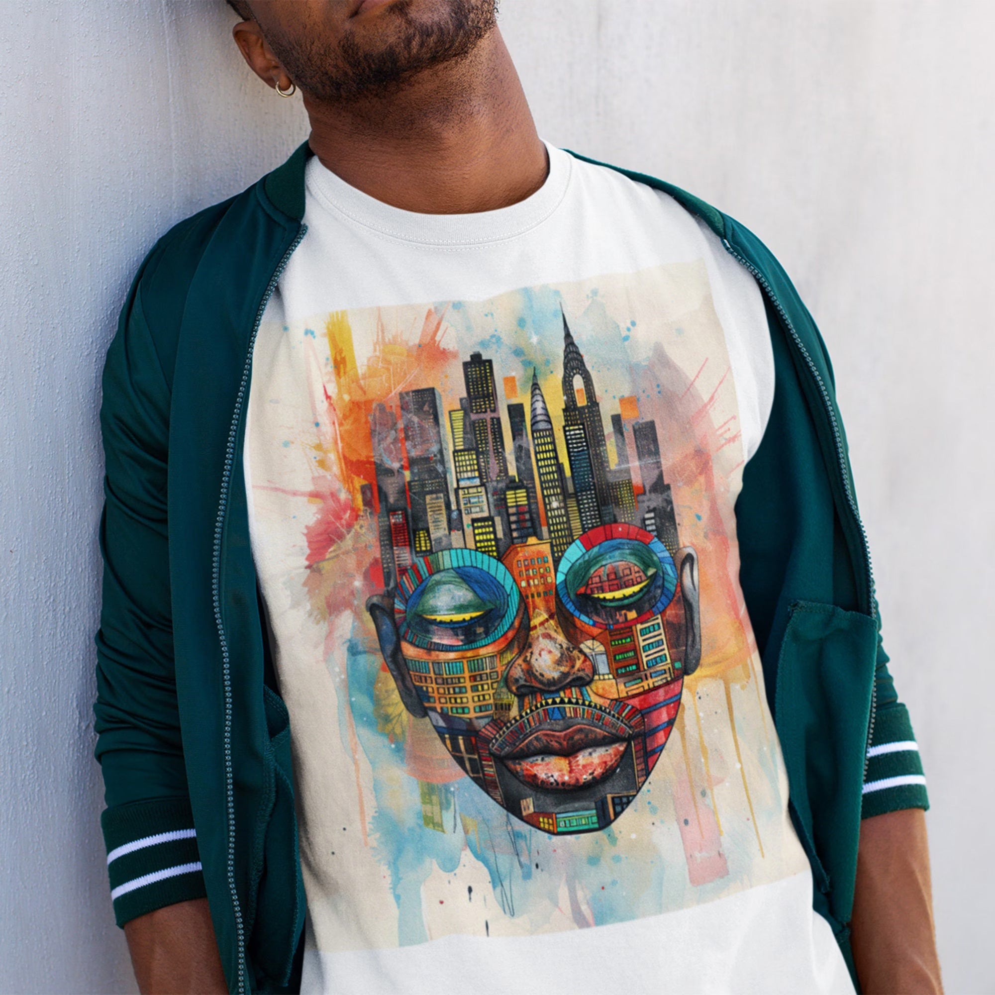 Afrocentric graphic t-shirt featuring an abstract African mask blended with the New York City skyline in a colorful watercolor style design celebrating Black culture and NYC pride.
