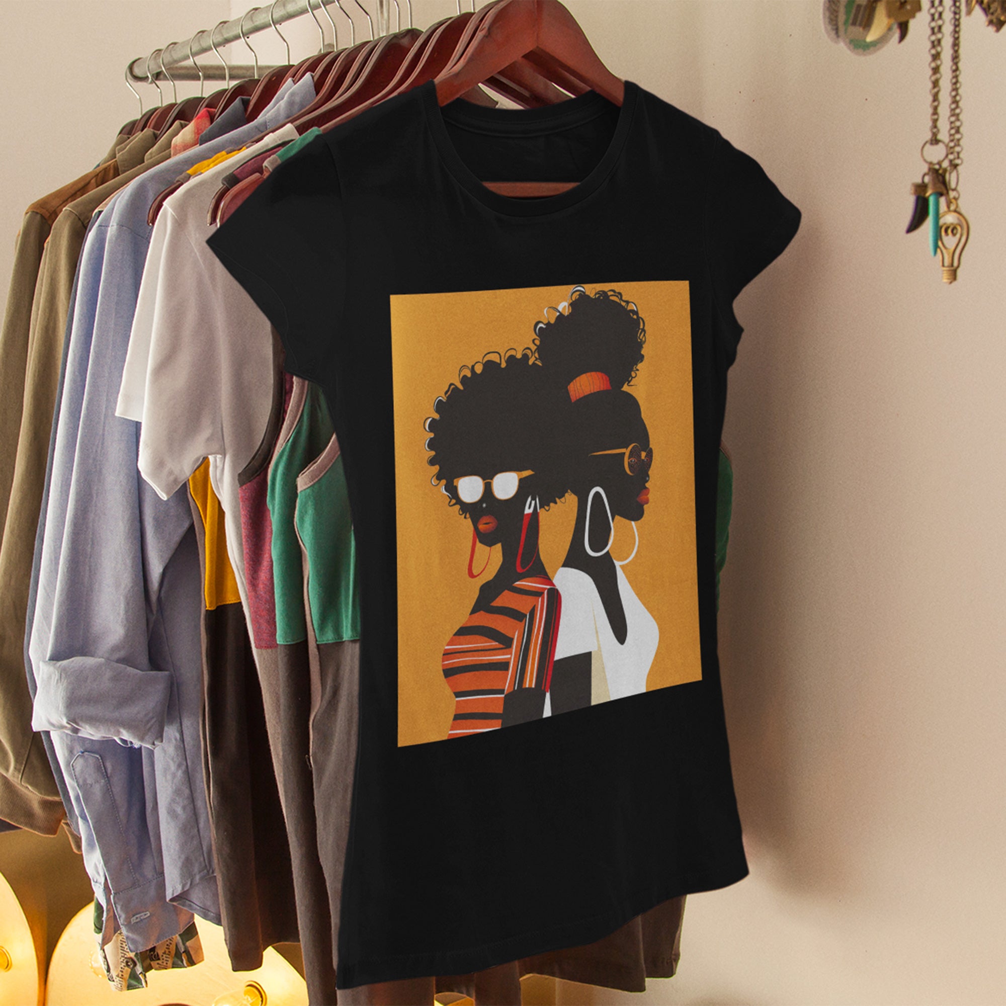Two Black Women silhouette wearing fashionable eyewear on an orange background, featured on an Afrocentric unisex tee shirt