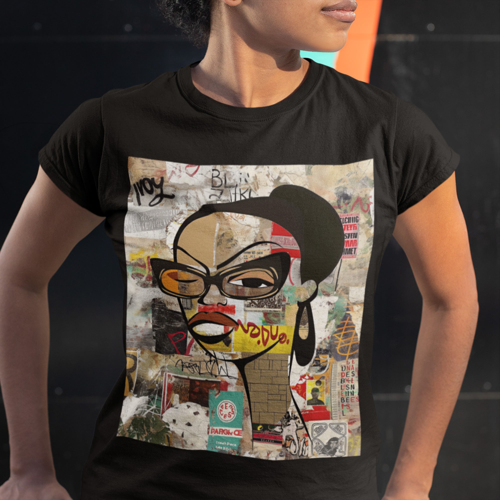 Graphic tee featuring an abstract cartoon-style illustration of a confident Black woman with stylish black-framed eyeglasses and a one-eyed inquisitive stare. The design has a bold, graffiti-inspired look that celebrates Black girl magic, attitude, and self-expression.