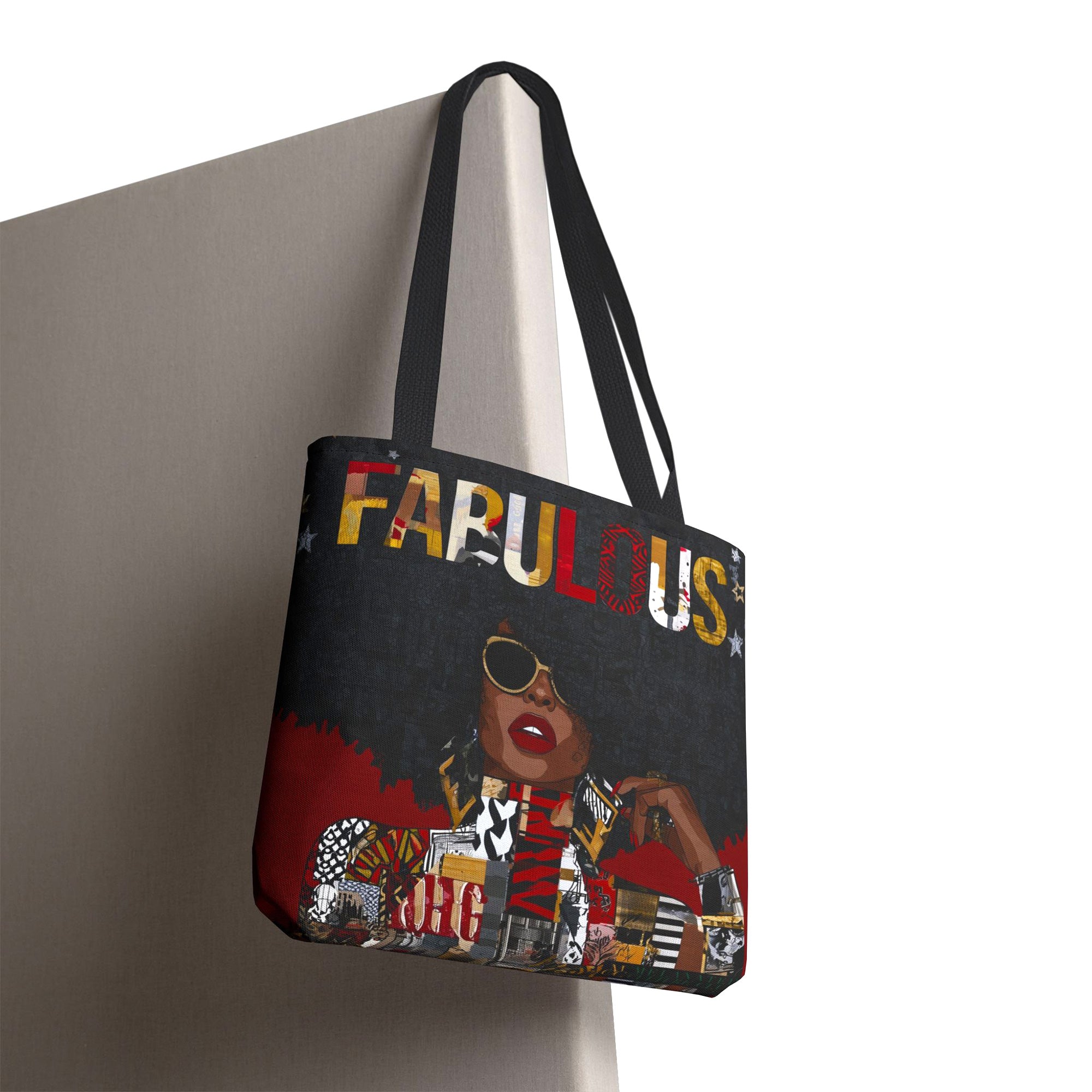 Fabulous Black woman tote bag featuring an abstract Afrocentric female portrait in colorful pop art and graffiti style with the word Fabulous in large graphic letters, hanging from the edge of a board.