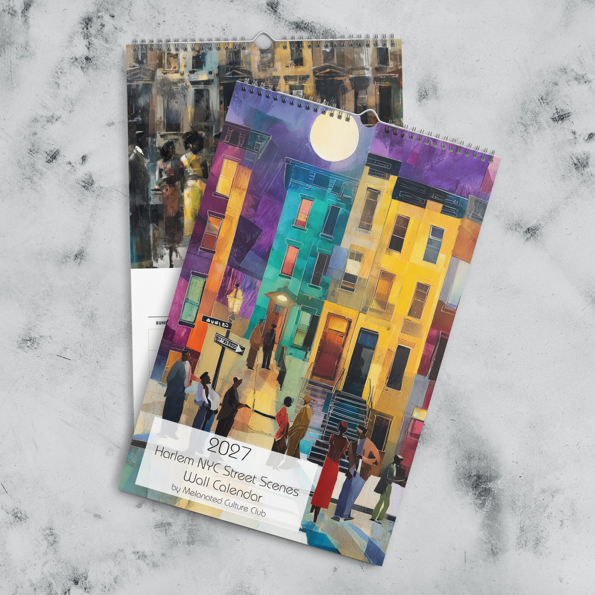 Front cover and December month page of an 11" x 17" 2027 Harlem wall calendar featuring abstract African American art of Black people experiencing New York City street life, historic Harlem brownstones, and scenes inspired by Black culture and the Harlem Renaissance era.  Displayed against a marble background.