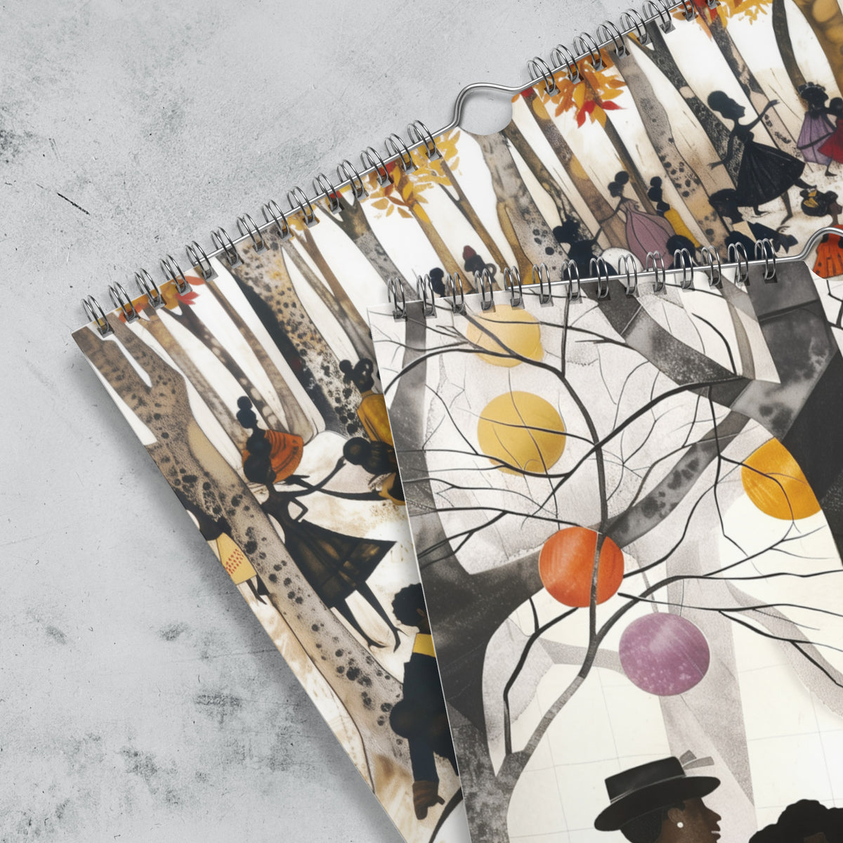 Close up detail of silver hanging wire and grommets of an 11" x 17" 2027 Picnic in the Park Wall Calendar featuring vibrant African American artwork celebrating Black families enjoying a joyful outdoor picnic in a beautiful park setting. Colorful Afrocentric illustrations capture family gatherings, community, togetherness, and Black cultural traditions, displayed against a grey marble background.