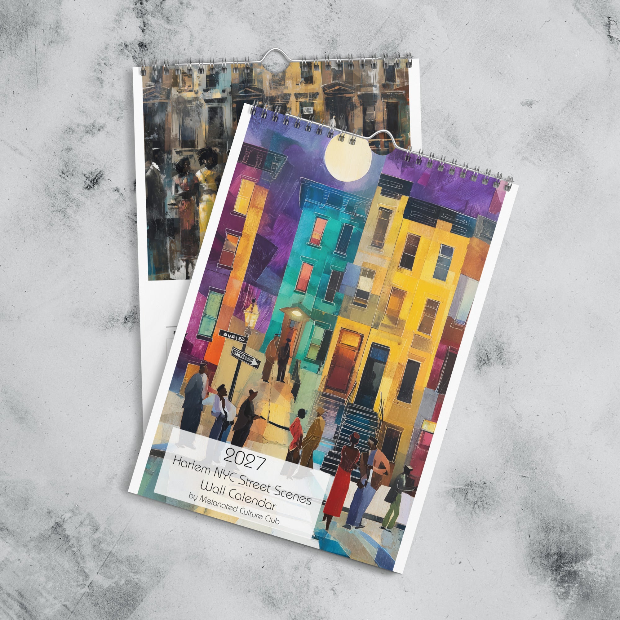 Front cover and January month page of an 11" x 17" 2027 Harlem wall calendar featuring abstract African American art of Black people experiencing New York City street life, historic Harlem brownstones, and scenes inspired by Black culture and the Harlem Renaissance era.  Displayed against a marble background.