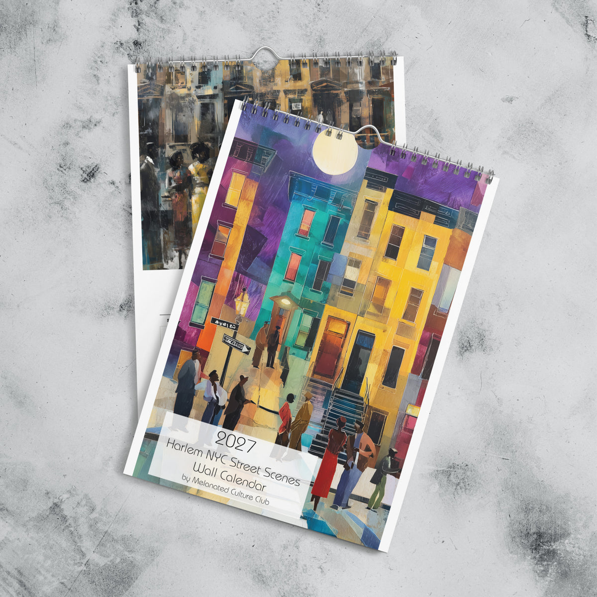 Front cover and January month page of an 11" x 17" 2027 Harlem wall calendar featuring abstract African American art of Black people experiencing New York City street life, historic Harlem brownstones, and scenes inspired by Black culture and the Harlem Renaissance era.  Displayed against a marble background.